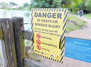 TAPLOW 134647-1. Flowers left at the Jubilee River in memory of Ruben Iwe , who died aged 16 in the river in June 2022.