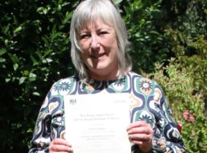 Woman achieves highest award for playing piano