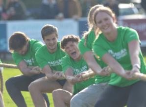 Athletes do battle in tug of war for cancer charity