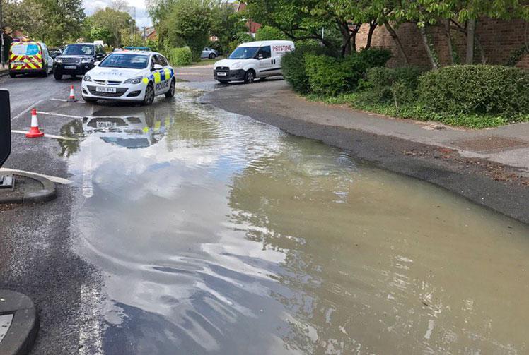 Burst water main spills onto road in Wootton Way 
