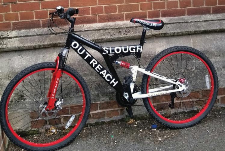 Slough Outreach project presented with fixed up bicycle
