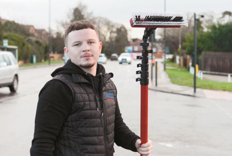 Window washer cleans street signs for free so elderly can see them better