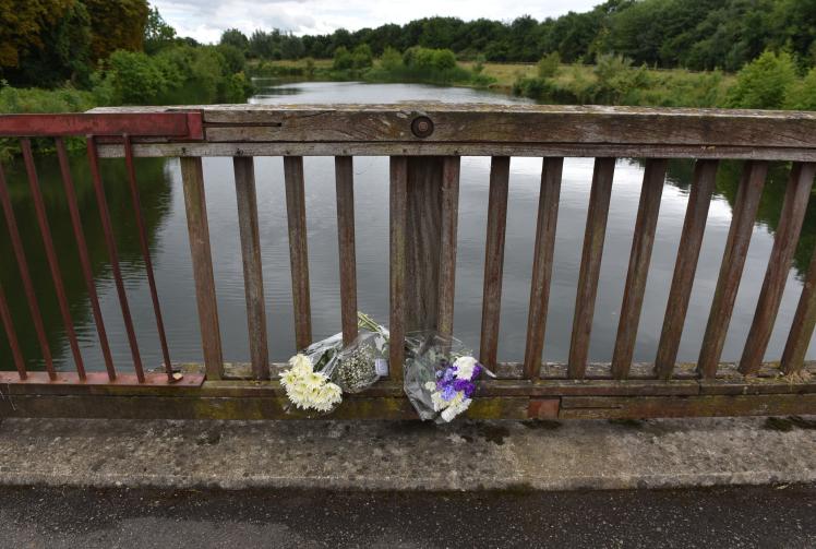 TAPLOW 134647-1. Flowers left at the Jubilee River in memory of Ruben Iwe , who died aged 16 in the river in June 2022.